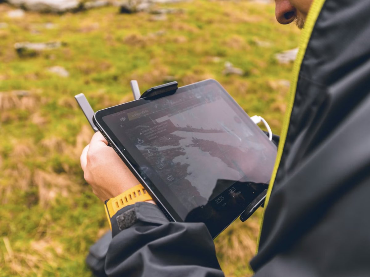 A field technician reviewing data on a tablet outdoors